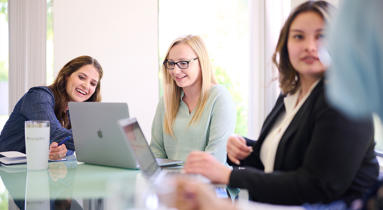 Nuspire team in office meeting room