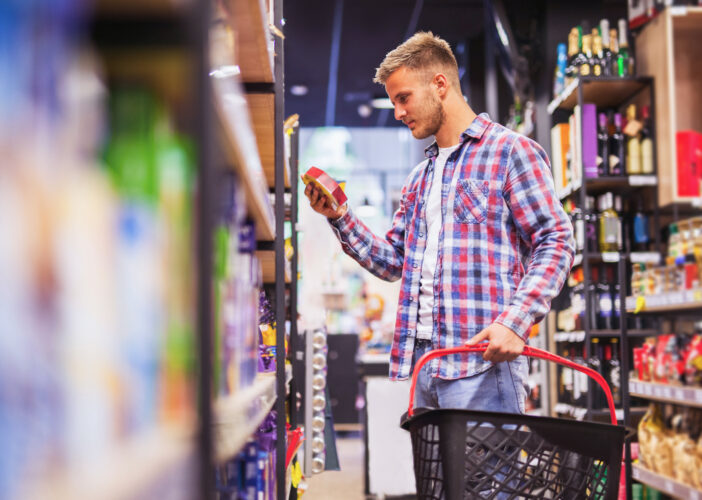 Retail customer browsing store shelves, reflecting the trust shoppers place in secure retail environments, in person and online.
