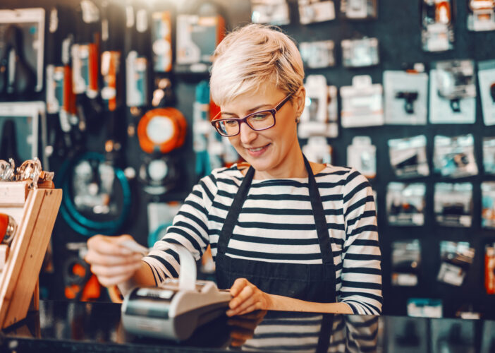 Retail associate completing a sale at a POS terminal, illustrating how a strong cybersecurity strategy—including network segmentation—keeps operations running smoothly